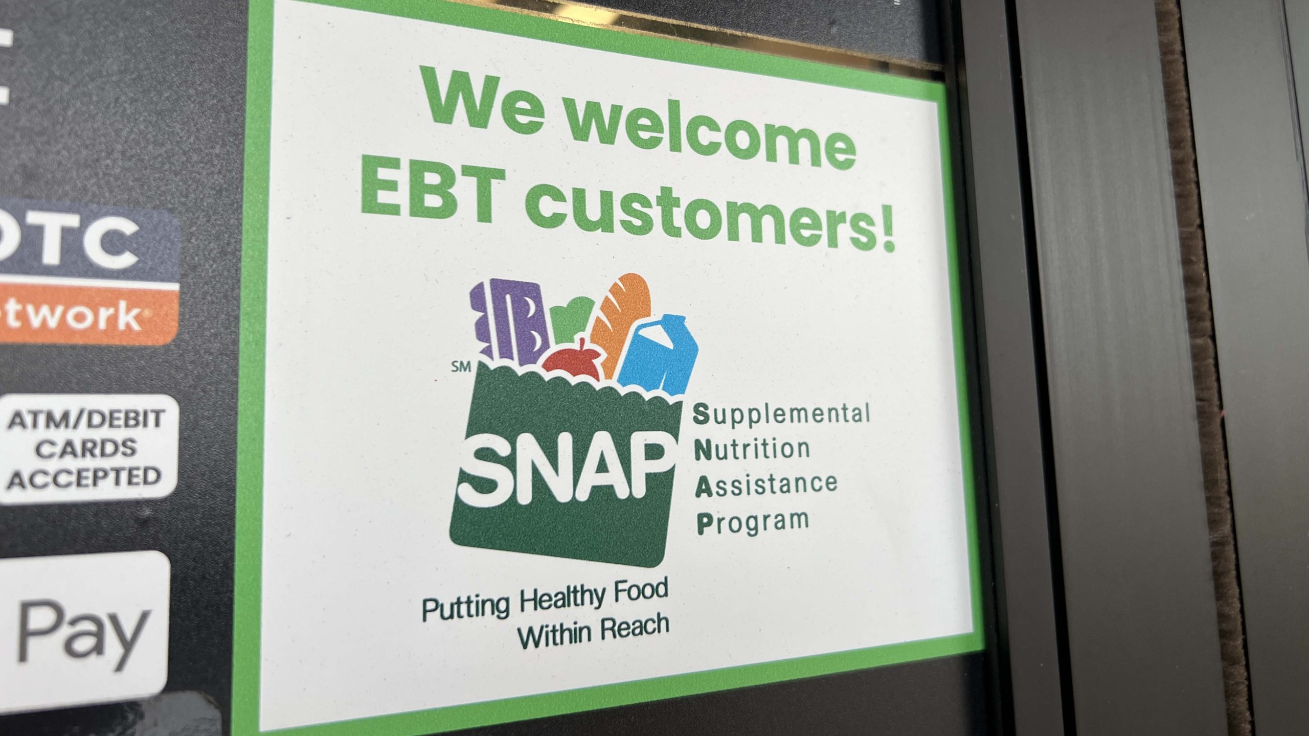 Family grocery shopping for healthy food items with SNAP benefits